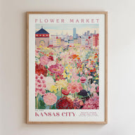 A framed poster depicting a vibrant flower market in Kansas City, with a cityscape in the background.