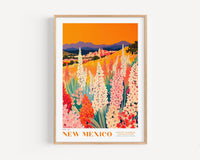 The image is a framed poster depicting a vibrant landscape with a field of colorful flowers, mountains in the background, and a warm orange sky.
