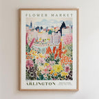The image is a framed poster depicting a vibrant and colorful flower market in the city of Arlington, with a variety of flowers and plants in the foreground and a cityscape in the background.