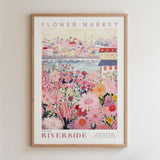 The image is a framed poster depicting a vibrant and colorful flower market scene with a cityscape in the background.