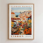 The image is a framed poster depicting a colorful and vibrant flower market in Lisbon, Portugal.