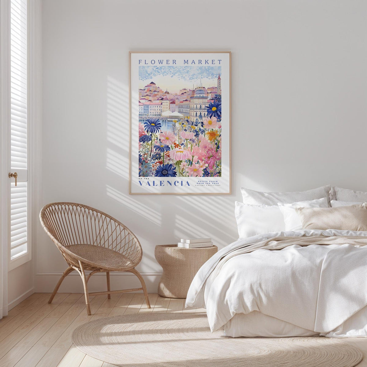 a bedroom with a large poster of a flower market in the background, a woven chair, and a bed with white bedding.