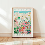 A framed poster depicting a colorful and vibrant flower market in Mykonos, Greece.