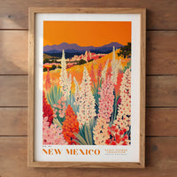The image is a framed poster depicting a vibrant landscape of flowers in New Mexico, with mountains in the background.