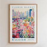 A framed poster depicting a vibrant and colorful flower market in Raleigh, North Carolina.