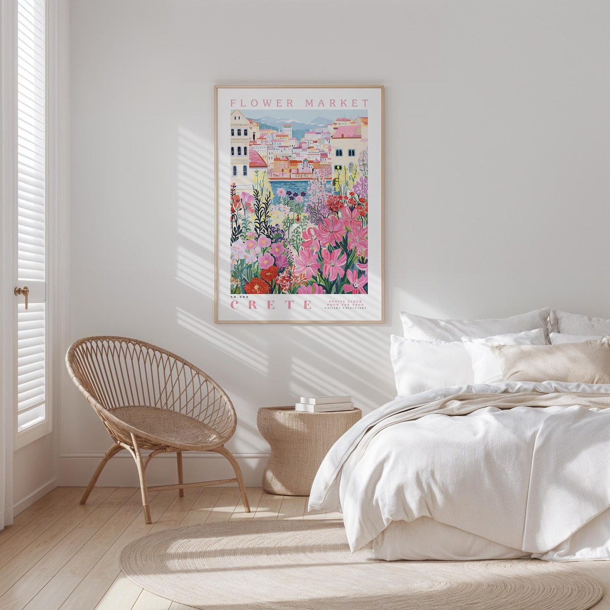 a bedroom with a large poster of a flower market in Crete hanging on the wall. The poster features a colorful illustration of a flower market with buildings and flowers in the background. The room has a white bed, a woven chair, and a rug on the floor.