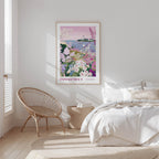 a serene bedroom scene with a large framed poster of a garden hanging on the wall, a woven chair, and a bed with white bedding.