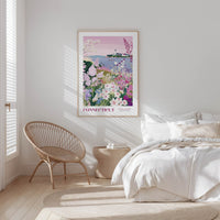 a serene bedroom scene with a large framed poster of a garden hanging on the wall, a woven chair, and a bed with white bedding.