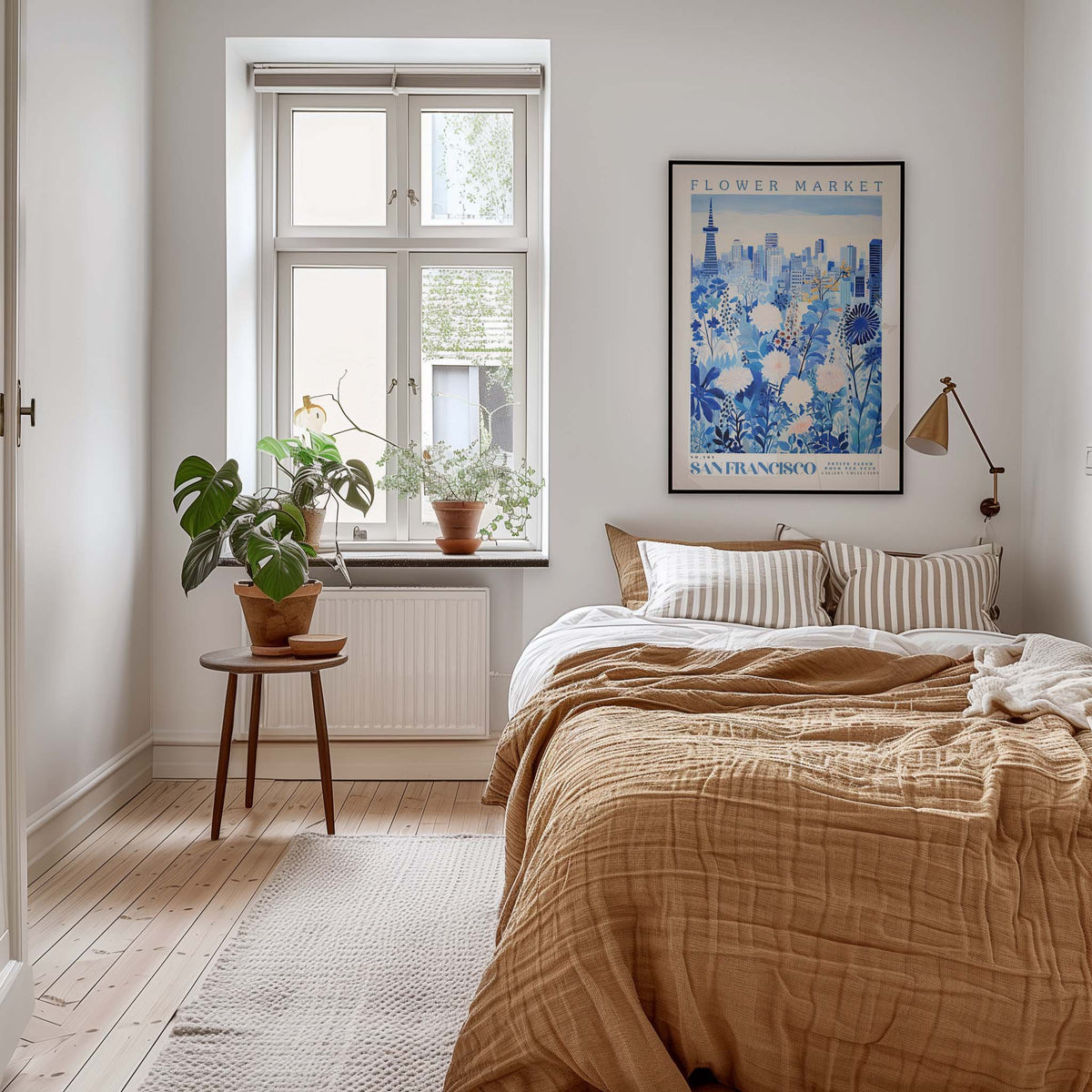 A cozy bedroom with a large bed, a nightstand with a plant, and a framed poster of a cityscape on the wall.