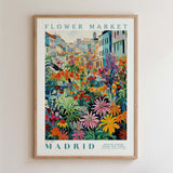 The image is a framed poster depicting a vibrant and colorful street scene in Madrid, Spain.