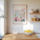 a kitchen scene with a framed poster of a cityscape and a bowl of lemons on a wooden countertop.