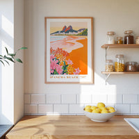 a kitchen counter with a bowl of lemons, a framed poster of Ipanema Beach, and a shelf with jars and containers.