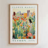 The image is a framed poster depicting a woman surrounded by a variety of colorful flowers and plants, with a cityscape in the background.