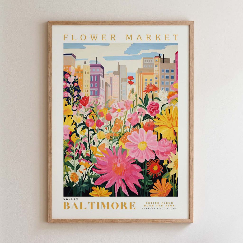 The image is a framed poster depicting a vibrant and colorful flower market in Baltimore, with a variety of flowers and plants in the foreground and a cityscape in the background.