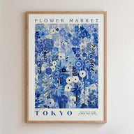 The image is a framed poster of a floral design with the text "FLOWER MARKET TOKYO" and "PETITE FLUER POUR TES FEUMS GALLERY COLLECTION" printed on it.