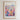 The image is a framed poster depicting a vibrant and colorful cityscape with a variety of flowers and plants in the foreground.