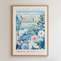 The image is a framed poster depicting a vibrant flower market in Virginia Beach, with a cityscape in the background.