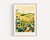 A framed poster depicting a vibrant field of sunflowers and other flowers, with wind turbines visible in the distance, set against a yellow sky.