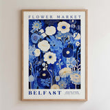 The image is a framed poster of a floral design with blue and white colors, featuring various flowers and plants.