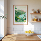 a kitchen counter with a bowl of lemons, a framed poster of Hanaole Beach, and a shelf with jars and bottles.