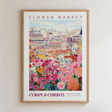 The image is a framed poster depicting a vibrant and colorful flower market scene with various flowers and buildings in the background.