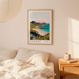 a bedroom with a framed poster of a scenic landscape hanging on the wall above a bed with striped bedding.