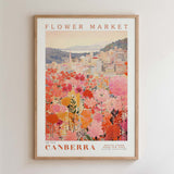 The image is a framed poster depicting a cityscape with a large flower field in the foreground.