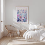 a bedroom with a bed, a woven chair, and a framed poster of a cityscape on the wall.