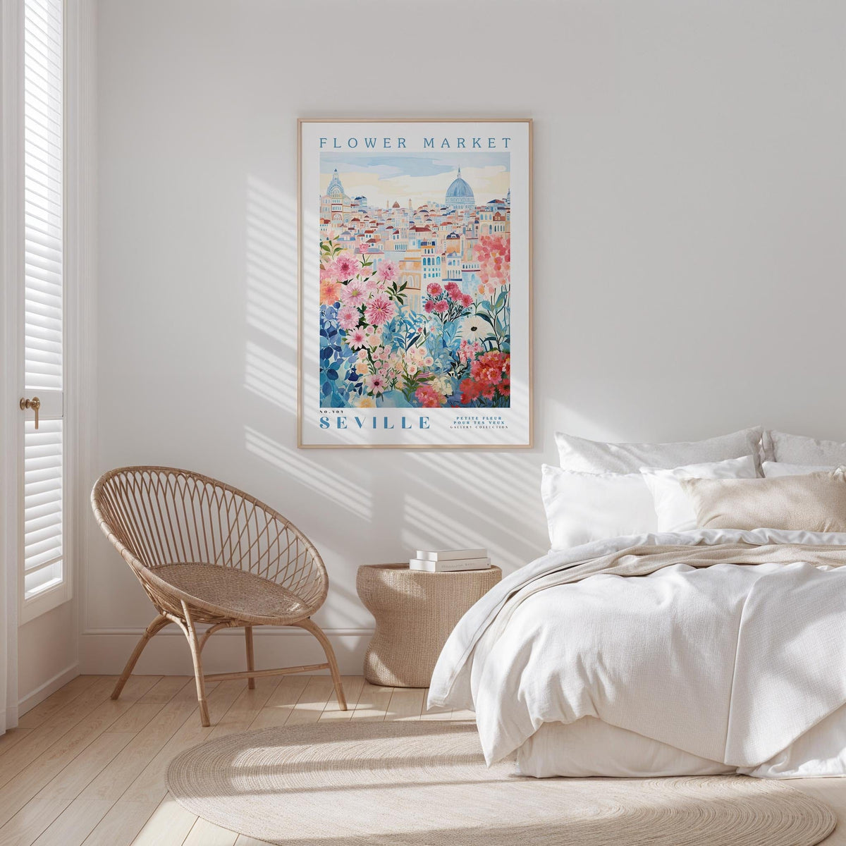 a bedroom with a large poster of a cityscape hanging on the wall, a woven chair, and a bed with white bedding.