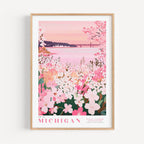 A framed poster depicting a scenic view of a lake surrounded by a field of pink flowers, with a bridge in the background.