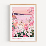 A framed poster depicting a scenic view of a lake surrounded by a field of pink flowers, with a bridge in the background.