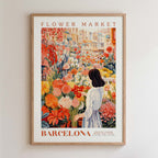 The image is a framed poster depicting a woman standing in a flower market in Barcelona, surrounded by a variety of colorful flowers.