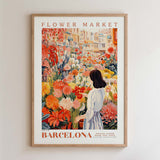 The image is a framed poster depicting a woman standing in a flower market in Barcelona, surrounded by a variety of colorful flowers.