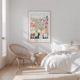 a bedroom with a bed, a woven chair, and a framed poster of a flower market in Warsaw hanging on the wall.