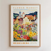 The image is a framed poster depicting a colorful and vibrant flower market in Heidelberg, Germany.