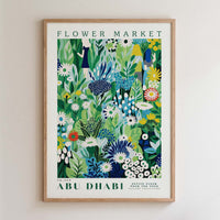 The image is a framed poster depicting a vibrant and colorful floral scene, with various flowers and plants in shades of green, blue, and yellow.
