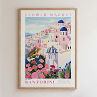 The image is a framed poster depicting a colorful and vibrant scene from the Santorini Flower Market in Greece.