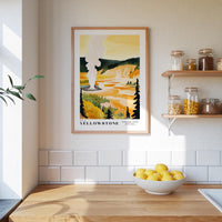 a kitchen counter with a bowl of lemons, a framed poster of Yellowstone National Park, and a shelf with jars and bottles.