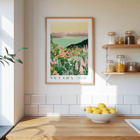 a kitchen scene with a framed print of a colorful landscape of flowers and mountains hanging on the wall above a wooden countertop. On the countertop, there is a bowl of lemons and a plant, and a shelf with various jars and containers.