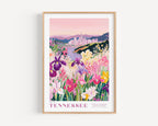 A framed poster depicting a vibrant field of colorful flowers, with a cityscape in the background.