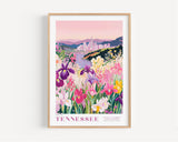 A framed poster depicting a vibrant field of colorful flowers, with a cityscape in the background.