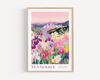 A framed poster depicting a vibrant field of colorful flowers, with a cityscape in the background.