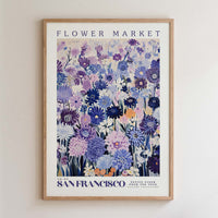 The image is a framed poster of a flower market in San Francisco, featuring a vibrant and colorful illustration of various flowers and plants.