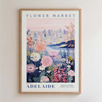 The image is a framed poster depicting a cityscape with a flower market in the background.