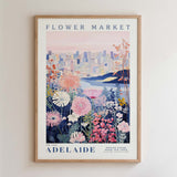 The image is a framed poster depicting a cityscape with a flower market in the background.