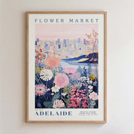 The image is a framed poster depicting a cityscape with a flower market in the background.
