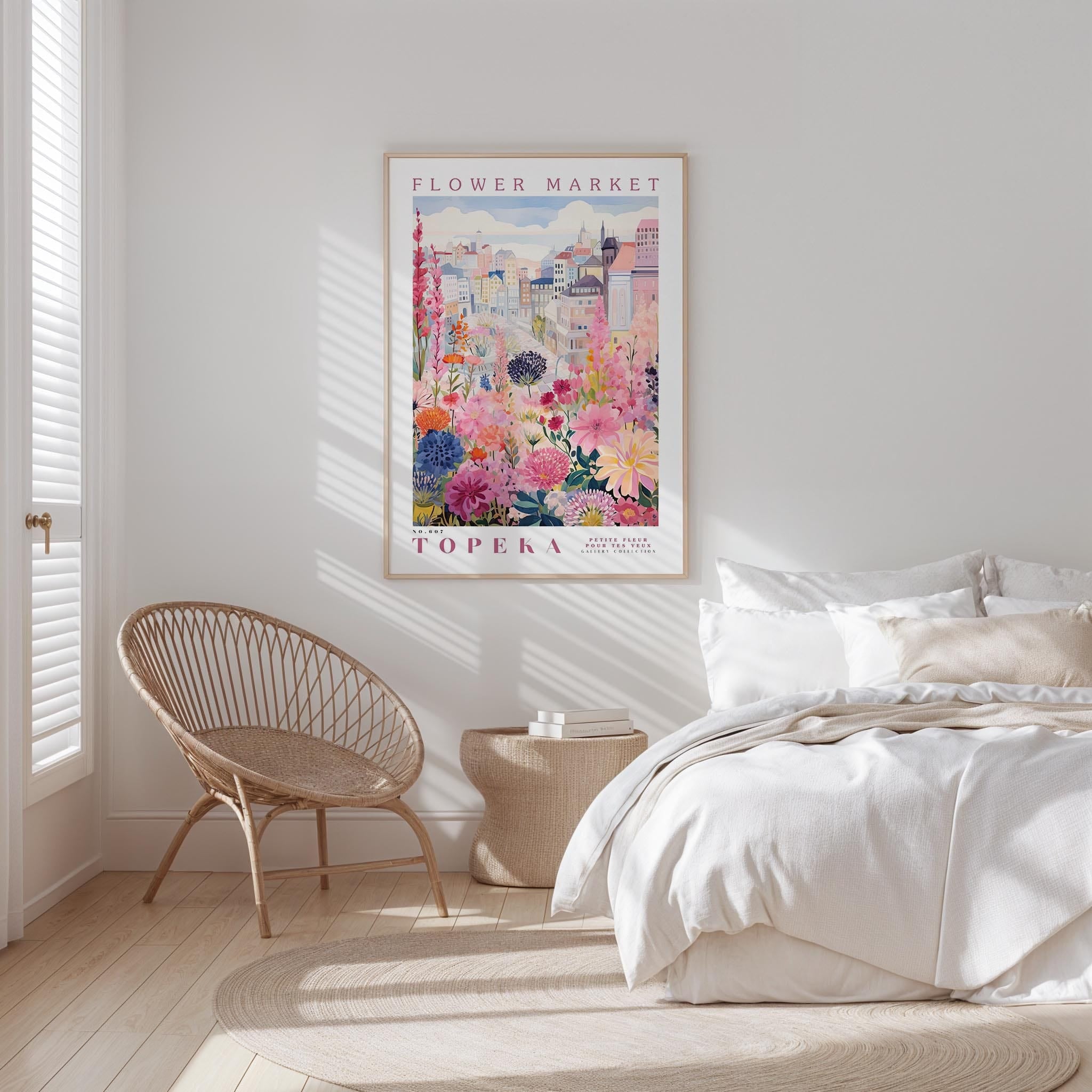 a bedroom with a bed, a wicker chair, and a framed poster of a flower market in Tenerife hanging on the wall.