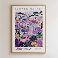 The image is a framed poster depicting a vibrant and colorful flower market in Amsterdam.