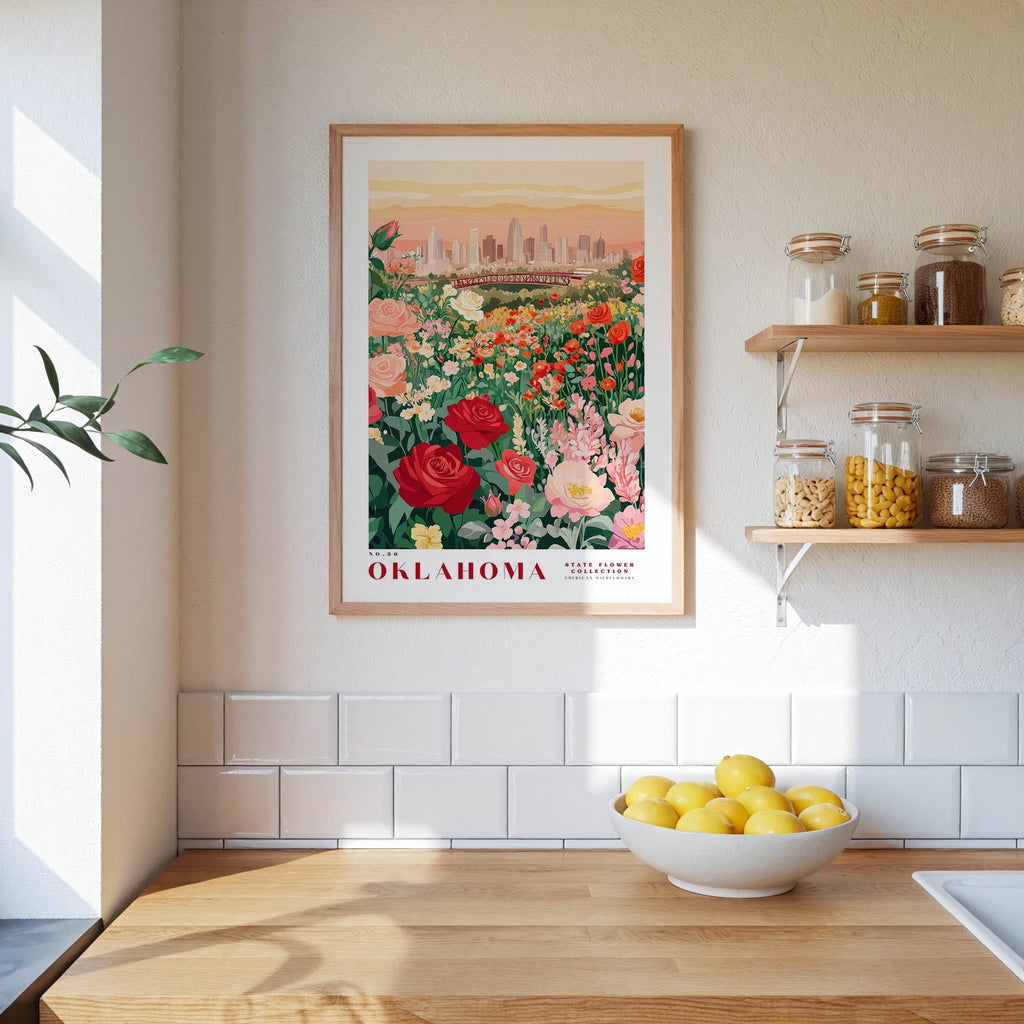 a framed poster of a garden with flowers hanging on a wall above a wooden countertop with a bowl of lemons.