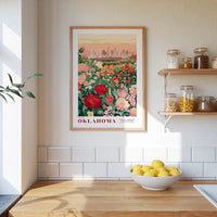 a framed poster of a garden with flowers hanging on a wall above a wooden countertop with a bowl of lemons.